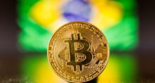 Golden bitcoin coin on a reflection surface with Brazil flag as background